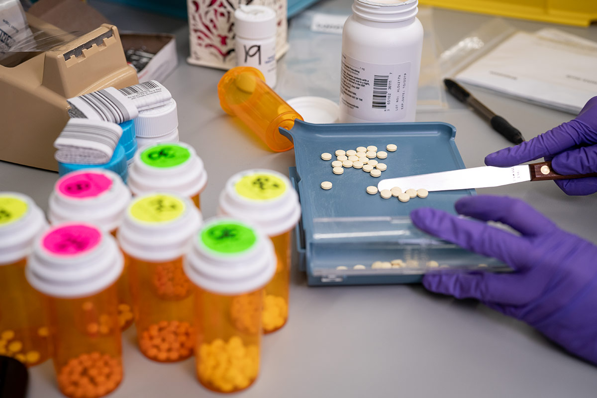 pills being separated out in pharmacy by technician